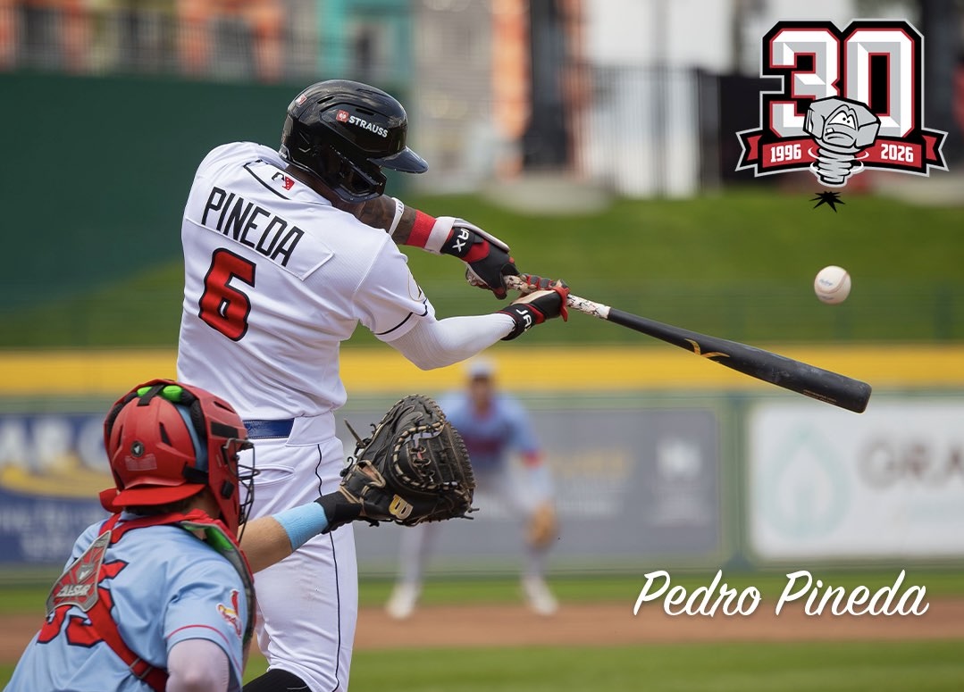 Baseball player Pedro Pineda (#6) swings at a pitched ball during a game, catcher in red gear behind him, with a 30th anniversary logo in the corner.